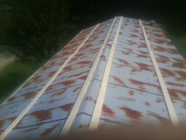Rusted metal roof panels with new wood purlins before replacement — Storm Damage Roof Repair in Los Lunas by Roofing Brothers